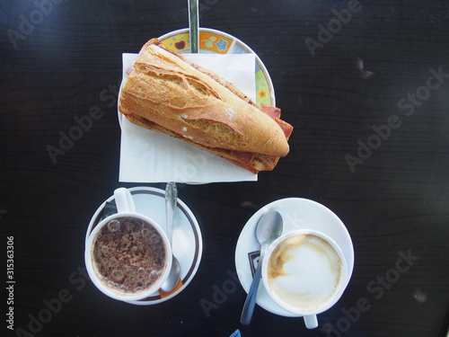 Fresh sandwiche with ham, Hot chocolate, Cafe latte, Camino de Santiago, Way of St. James, Journey from Gonzar to Ligonde, French way, Spain photo