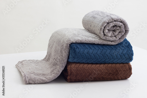 stack of folded soft blankets photo