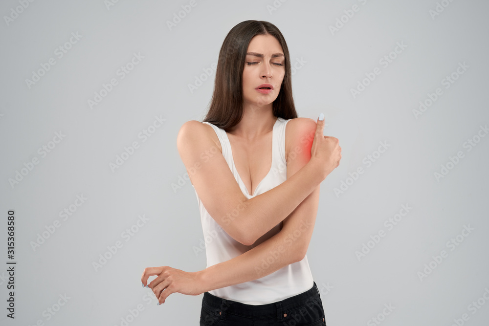 Woman showing pain in shoulder. Woman showing pain in shoulder.