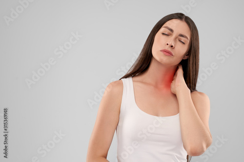 Woman touching neck because of pain.