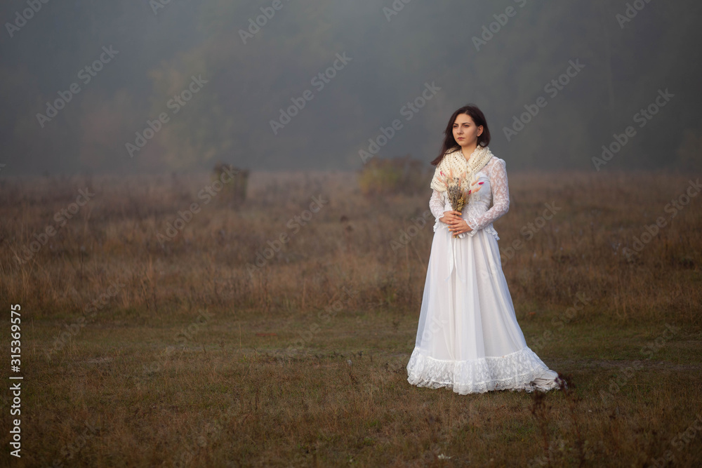 girl in a white dress on a mist field with oaks girl in a white dress on a mist field with oaks