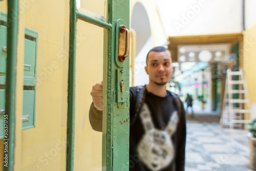 Young guy stands in the open doorway