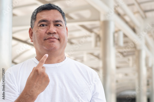 senior old man pointing at himself; concept of self volunteer, pride, proud senior, participation, confident retired senior old man