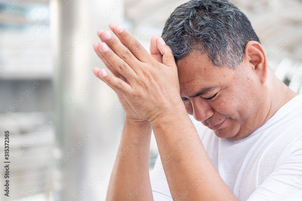 superstitious old senior man praying to spirit, ghost for luck; concept of fortune telling, superstition superstitious old senior man praying to spirit, ghost for luck; concept of fortune telling, superstition