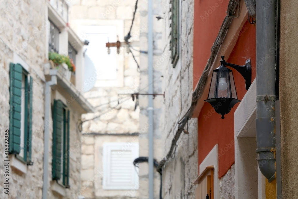 Retro style street lamp and traditional Mediterranean architecture in Split, Croatia. Selective focus. Retro style street lamp and traditional Mediterranean architecture in Split, Croatia. Selective focus.
