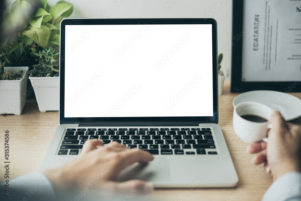 mockup image blank screen computer with white background for advertising text,hand woman using laptop contact business search information on desk at coffee shop.marketing and creative design