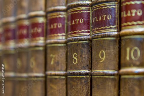 close-up of some antique volumes of works of the greek philosopher Plato