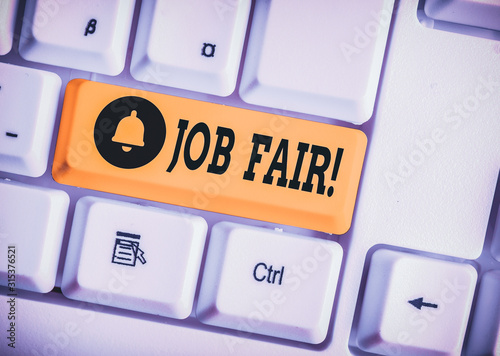 Writing note showing Job Fair. Business concept for event in which employers recruiters give information to employees White pc keyboard with note paper above the white background photo