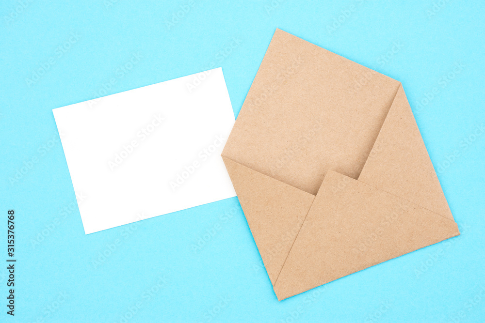 Envelope from craft paper with a blank on a blue background Envelope from craft paper with a blank on a blue background