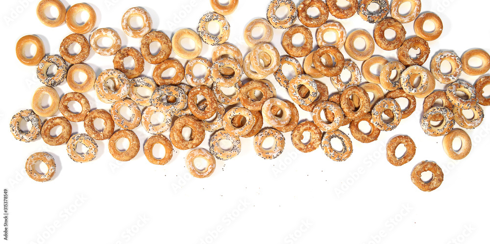 Pile of ring shaped roll cookies with different glaze isolated on white background. Bublik cookies pattern. . - obrazy, fototapety, plakaty 