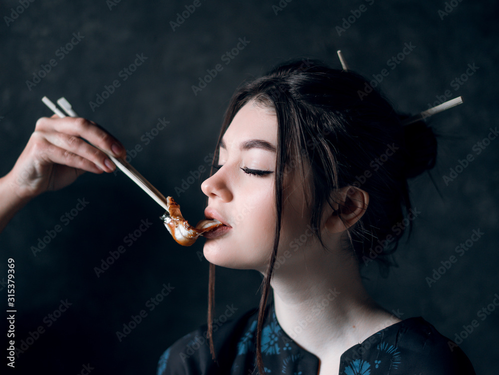 Fototapeta premium Cute girl eat eel salad