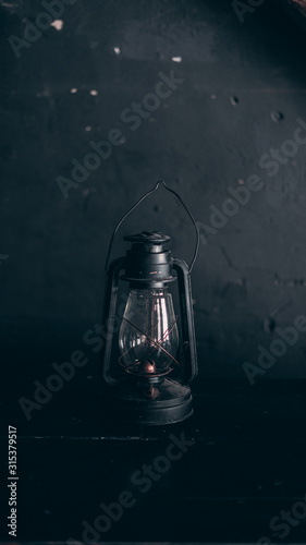 black old kerosene lamp on a black background