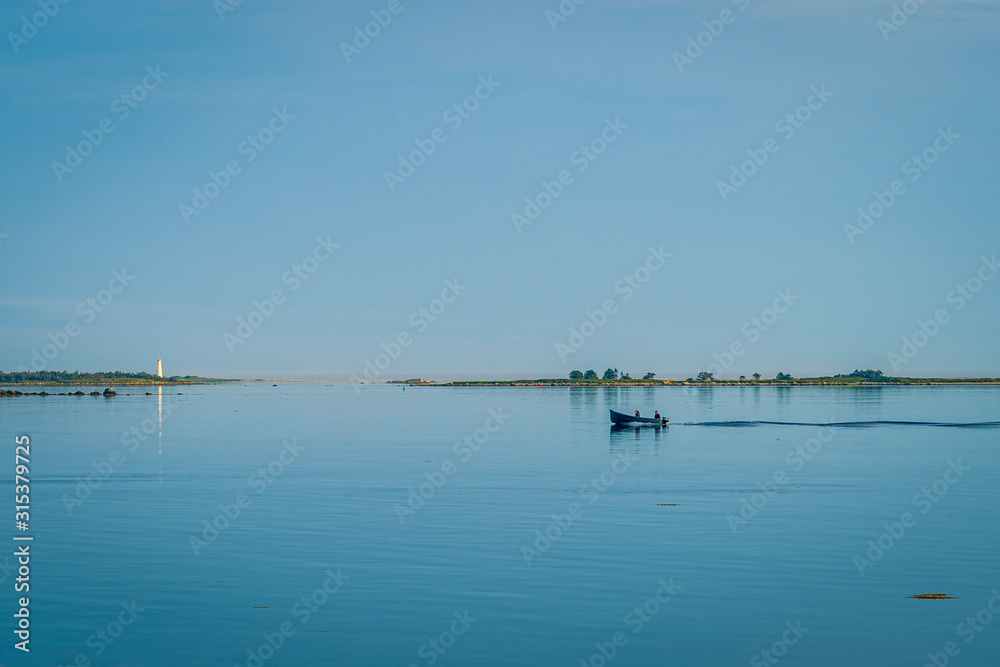 Rocky sea coast shoreline with distant lighthouse. Rocky sea coast shoreline with distant lighthouse.