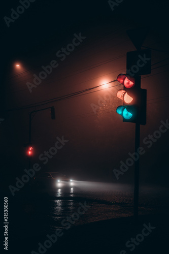 traffic light at night in the fog