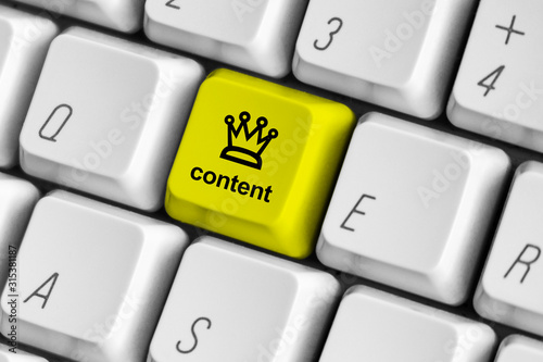 Yellow content is king key on the white computer keyboard.