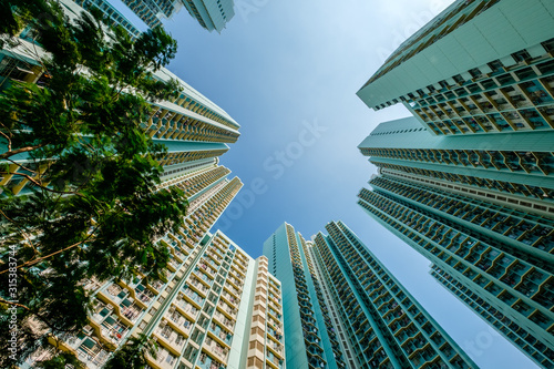 looking up on high-rise apartment building, residential building facade, hongkong © hanohiki