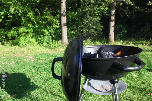 A grill preparing for cooking food outdoor starting picnic on sunny day