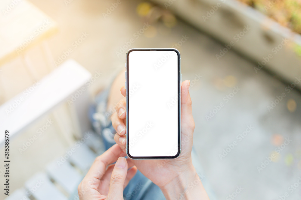 Mockup image blank white screen cell phone.man hand holding texting using mobile sitting at coffee shop.background empty space for advertise text.people contact marketing business,technology Mockup image blank white screen cell phone.man hand holding texting using mobile sitting at coffee shop.background empty space for advertise text.people contact marketing business,technology