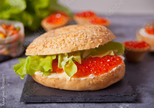 Fresh red caviar on bread. Sandwiches with red caviar and tartles with red caviar. Delicatessen. Gourmet food
