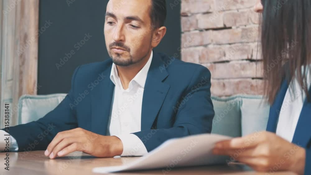 Two businesspeople work in a cafe. Boss is signing the contract. Crop. Close up. Copy space.