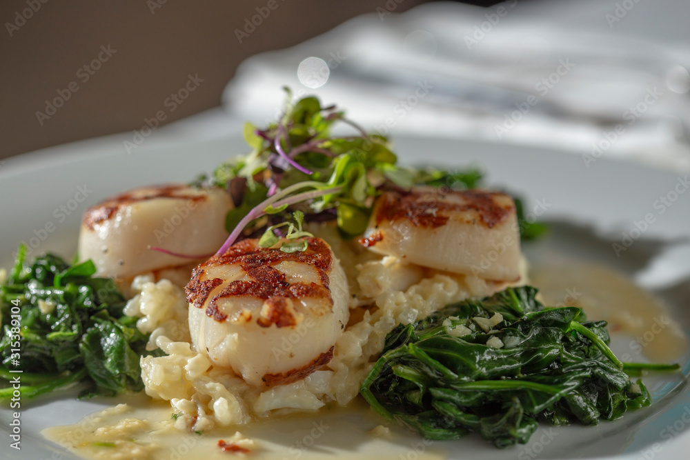 Grilled Scallops dinner in restaurant setting Grilled Scallops dinner in restaurant setting
