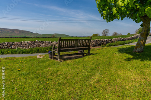 A bench with a view over the Yorkshire Dales near Hartlington, North Yorkshire, England, UK