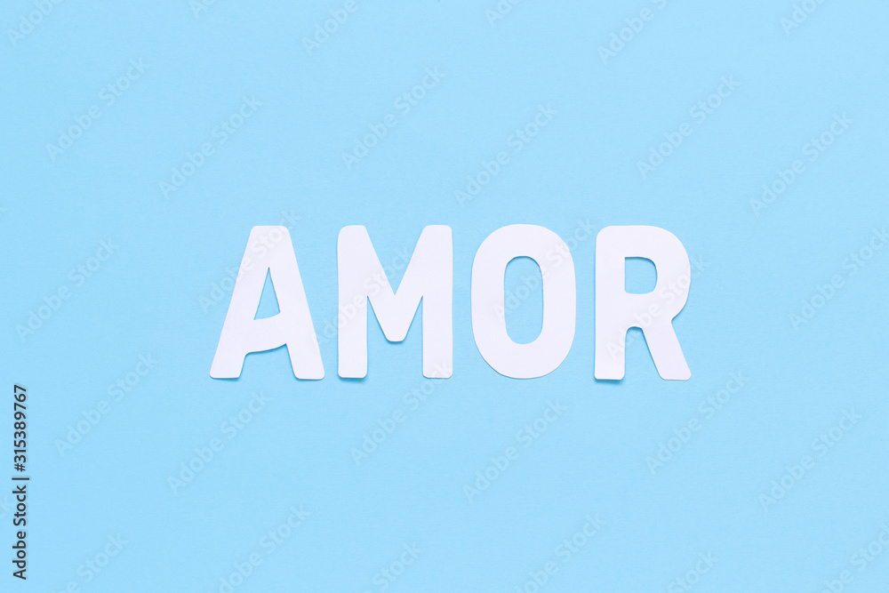 Fototapeta premium Word AMOR on a light blue background