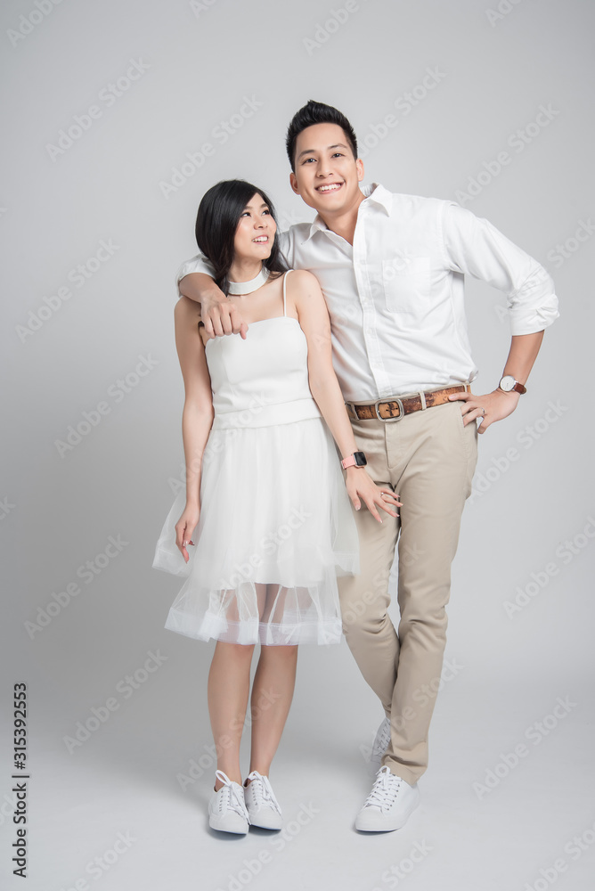Happy Asian groom embracing his bride in casual wedding dress Happy Asian groom embracing his bride in casual wedding dress