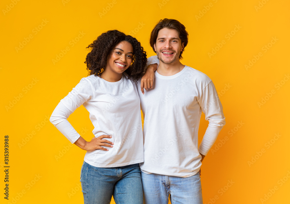 Portrait of happy interracial couple hugging and posing to camera Portrait of happy interracial couple hugging and posing to camera
