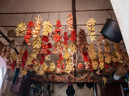 Vesuvius tomatoes called piennolo hung for winter preserves  in a rural kitchen, Naples, Campania, Italy, Europe photo