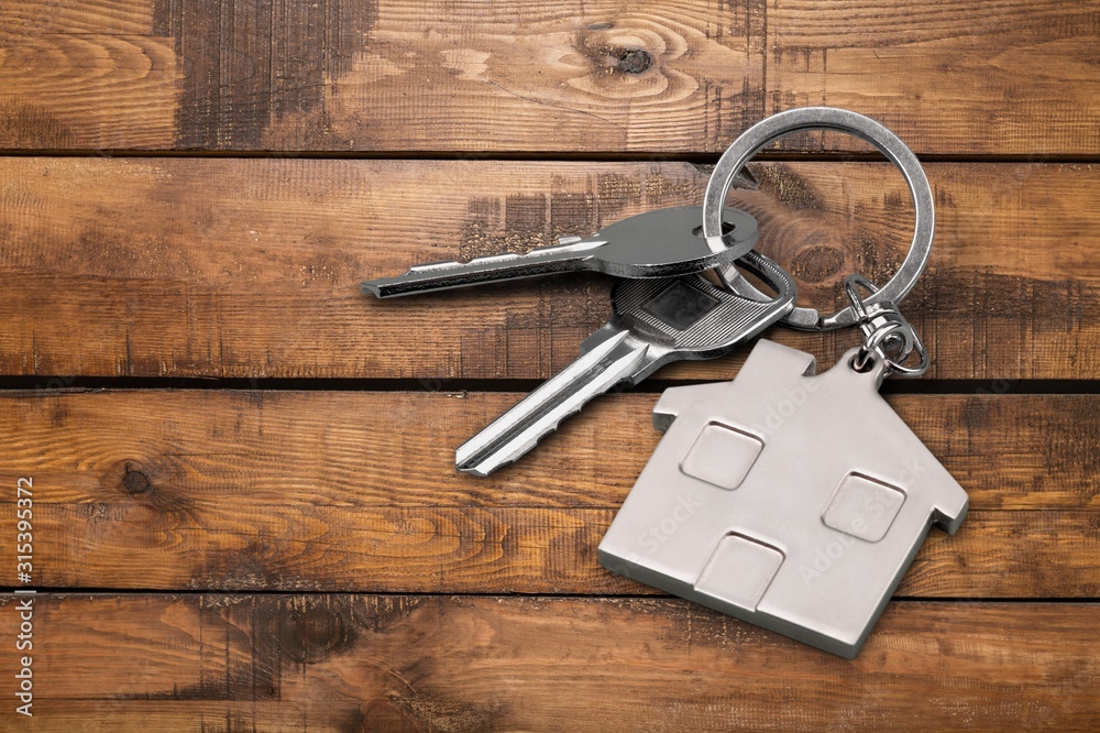 House metal keys on wooden floor background House metal keys on wooden floor background