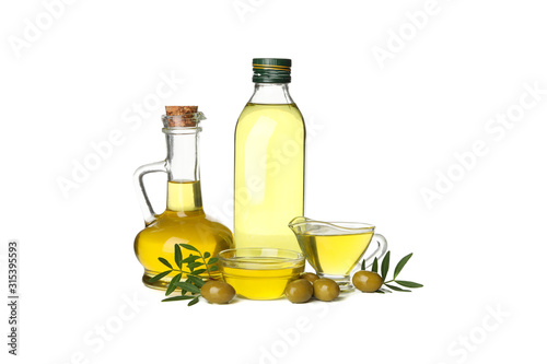 Glass bottle, jug and bowls with olive oil isolated on white background