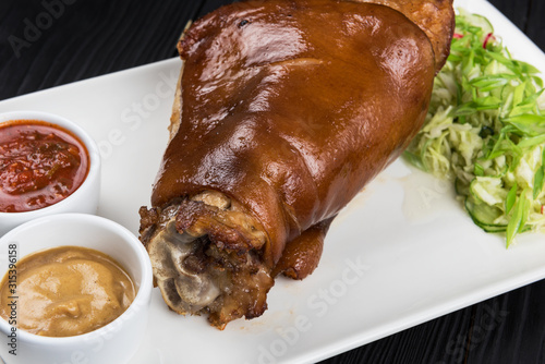 Tasty pork knuckle with sau...