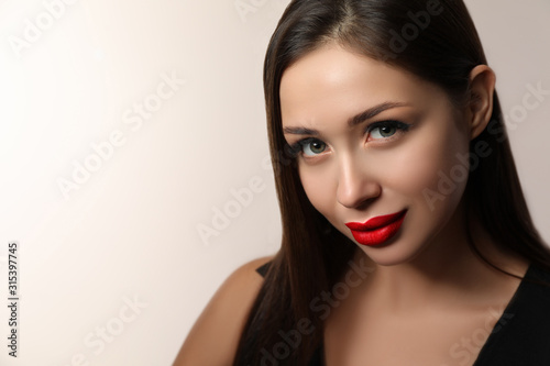 Beautiful woman with red lipstick on light background, space for text
