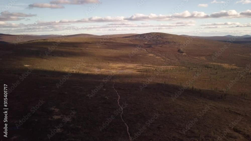 An AERIAL VIEW DOLLY SHOT of a hiking path and mountains. An AERIAL VIEW DOLLY SHOT of a hiking path and mountains.