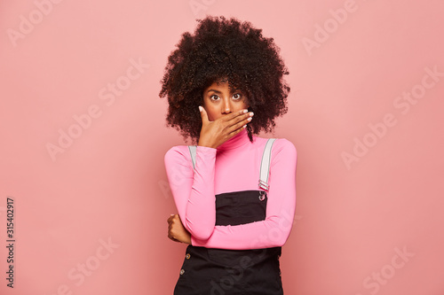 Shocked African American woman looking at camera