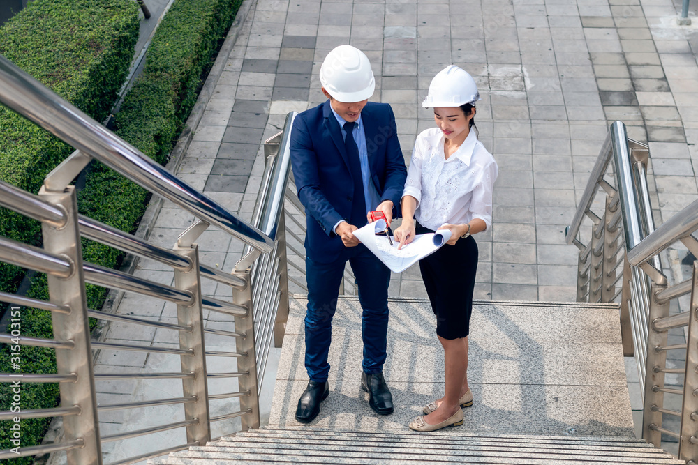 Handsome Asian business engineer of manager woman smiling and talking about success work with partners. Handsome Asian business engineer of manager woman smiling and talking about success work with partners.