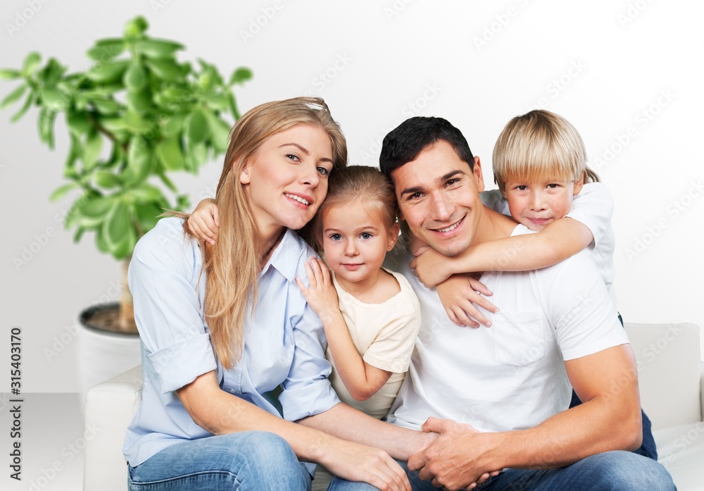 Beautiful smiling lovely family sitting on the sofa