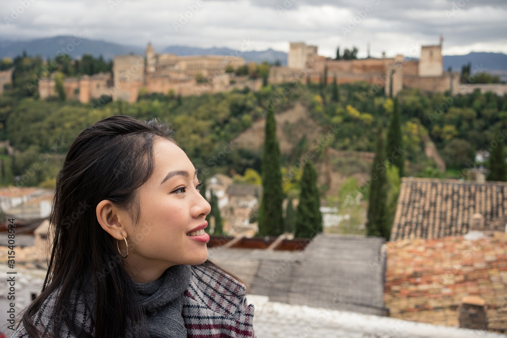 Content female enjoying view of big ancient castle Content female enjoying view of big ancient castle