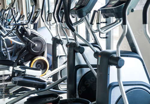 A number of cardio exercise machines - ellipsoids in a fitness center