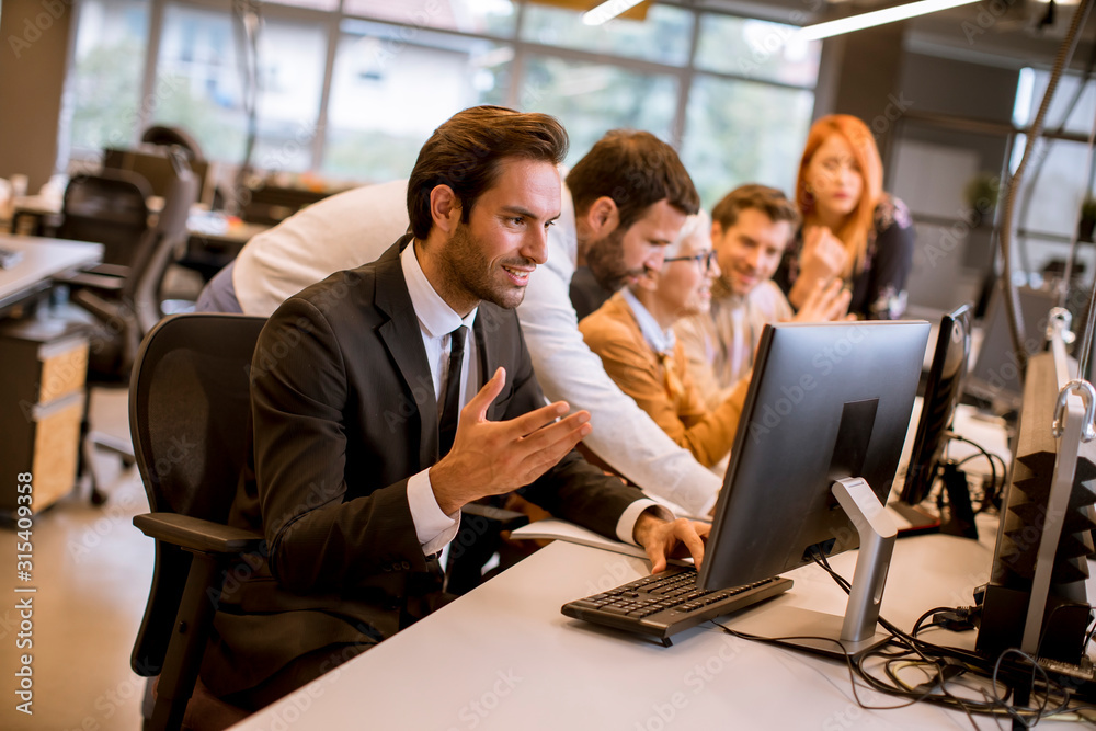 Young professional businessman uses a laptop for work in the office