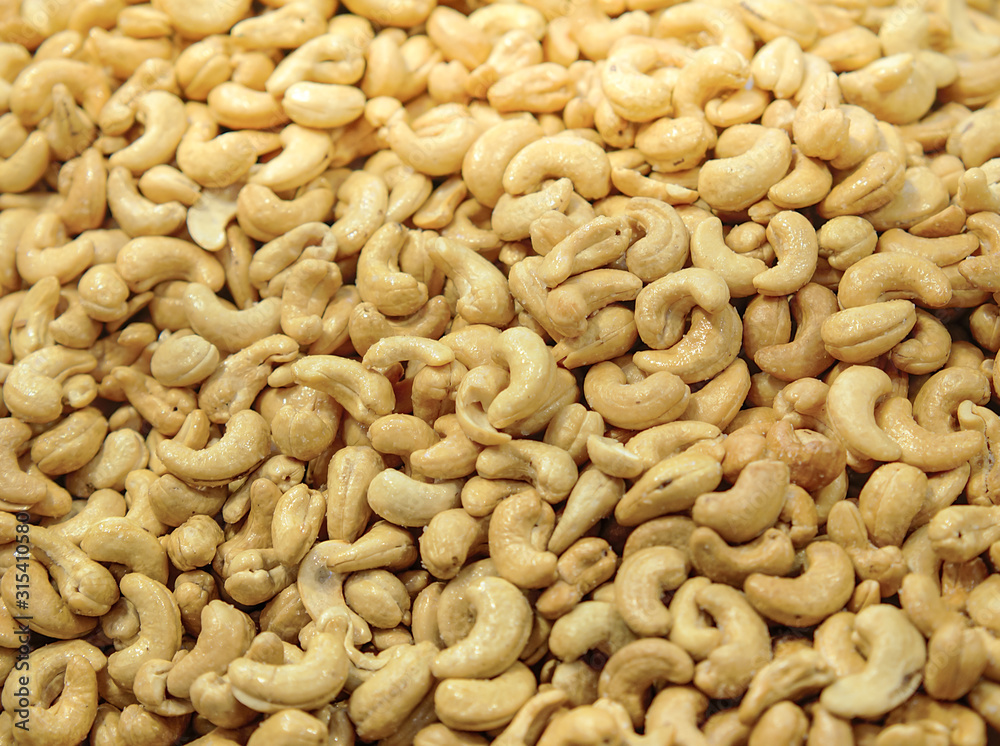 Roasted cashew nuts with honey sugar. Tasty sweet cashew nuts as textured and background. Roasted cashew nuts with honey sugar. Tasty sweet cashew nuts as textured and background.