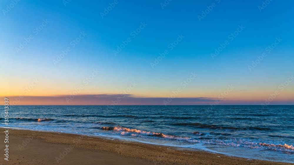 Sea beach in sunset colors