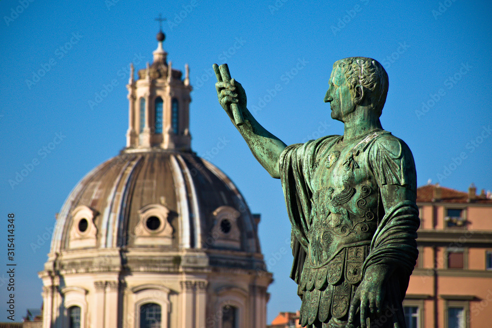 a statue with the dome of a church in Rome