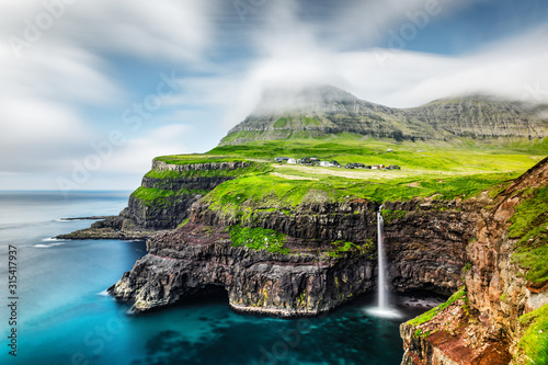 Fényképezés Incredible day view of Mulafossur waterfall in Gasadalur village, Vagar Island of the Faroe Islands, Denmark