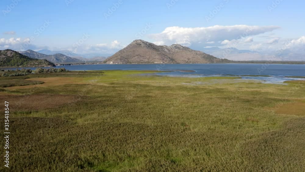 beautiful Eco Systems with Lake and amazing Mountain in National Park Lake Skadar in Virpazar Montenegro (aerial, drone) beautiful Eco Systems with Lake and amazing Mountain in National Park Lake Skadar in Virpazar Montenegro (aerial, drone)