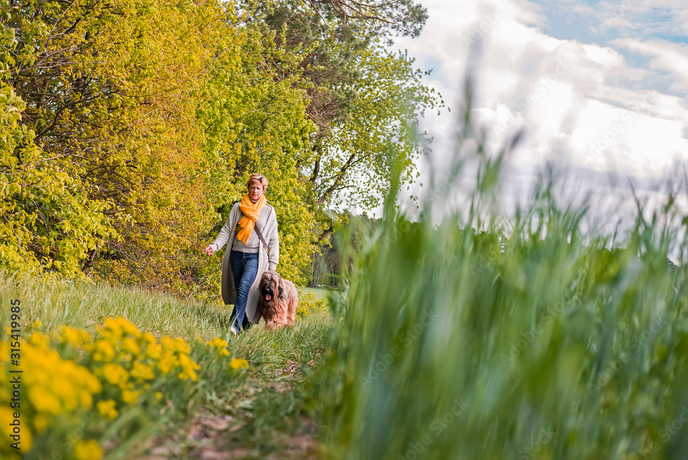 Woman going walkies with dog at a field Woman going walkies with dog at a field