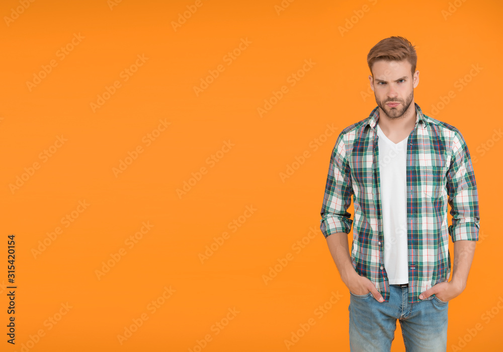 Make You Look Good. copy space. casual fashion for men. Masculine Outfits And Look. stylish male in fashionable clothing. handsome man in checkered shirt and jeans. student orange background Make You Look Good. copy space. casual fashion for men. Masculine Outfits And Look. stylish male in fashionable clothing. handsome man in checkered shirt and jeans. student orange background