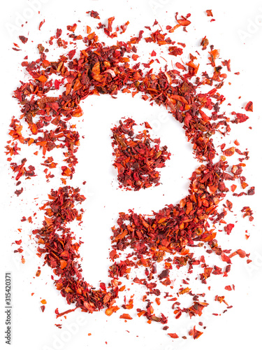 Crushed paprika in the shape of the letter p on a white background. Concept, copy space.