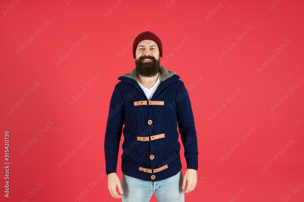 cheerful bearded man in knitted jacket. you need to dress warmly. male winter fashion. take care of beard hair in cold weather. autumn and winter collection. brutal hipster in hat